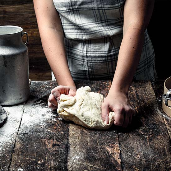 woman kneading dough