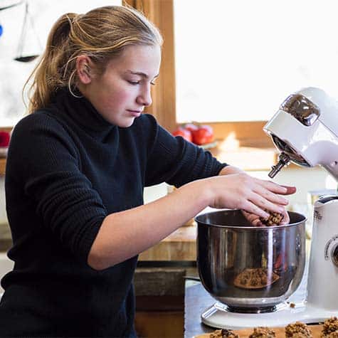 Woman using a kitchen aid during a baking class