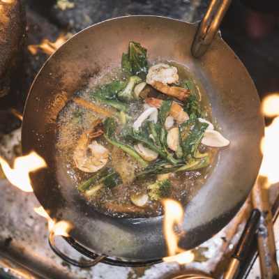 open fire cooking of vegetables and shrimp