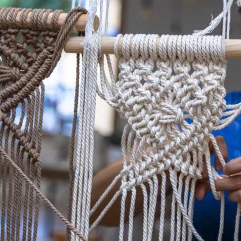 Woman weaving using yarn