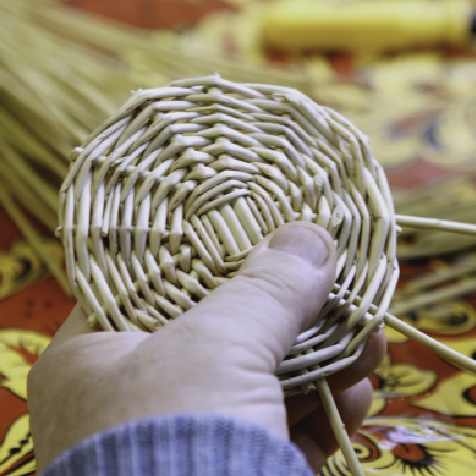 woman using cattails to weave