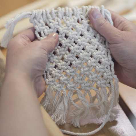 woman using yarn for her weaving project